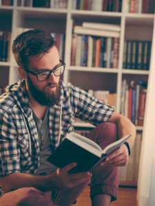 parent reading book on homeschooling and unschooling