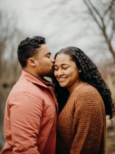 black married couple kissing and smiling