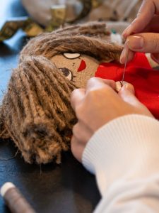 sewing a doll